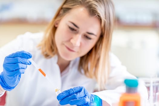 female scientist conducts chemical experiments in a research laboratory.