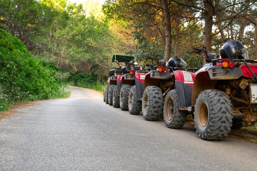 Parked ATV and UTV, mountain road. parked in a row several atv quad bikes extreme outdoor adventure concept