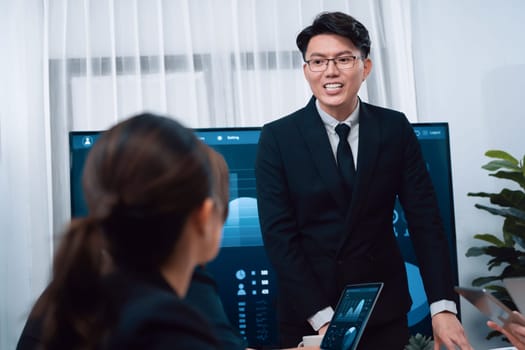 Confidence and asian businessman give presentation on financial analyzed by business intelligence in dashboard report to other people in board room meeting to promote harmony in workplace.