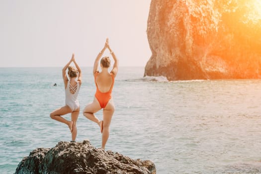 Silhouette mother and daughter doing yoga at beach. Woman on yoga mat in beach meditation, mental health training or mind wellness by ocean, sea