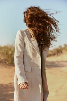 a strong wind inflates a woman with red, long hair. High quality photo