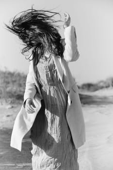 black and white photo of a woman in stylish summer clothes posing in nature. High quality photo