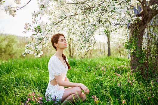 Young beautiful woman in a white dress posing in garden. High quality photo