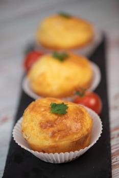 Savory muffin with ham and cheese on blue background, High quality photo