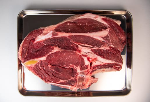 Raw cowboy steak with seasonings on white background, prime rib eye on bone, High quality photo
