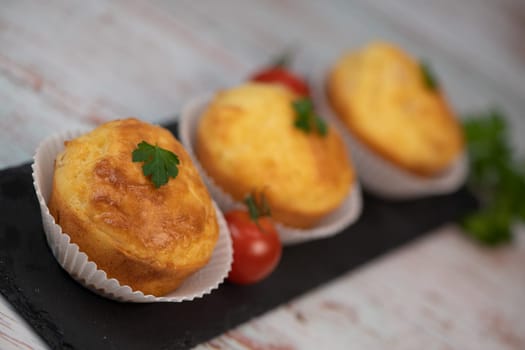 Savory muffin with ham and cheese on blue background, High quality photo