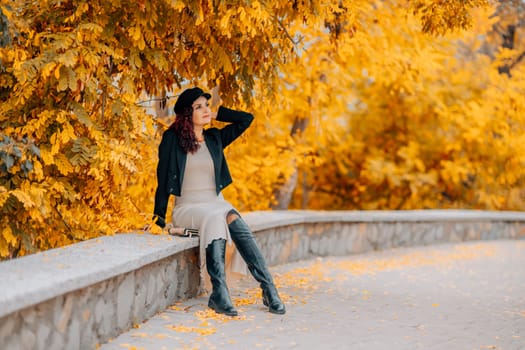 A woman walks outdoors in autumn, enjoys the autumn weather