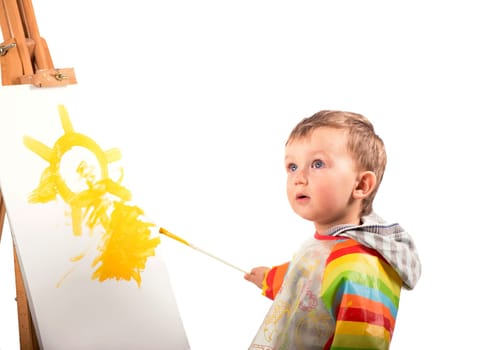The small artist draws on a white background