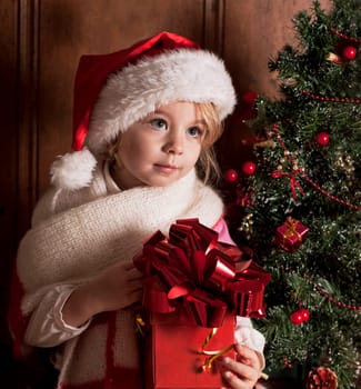 child in a suit of Santa Claus in the room decorated to new year