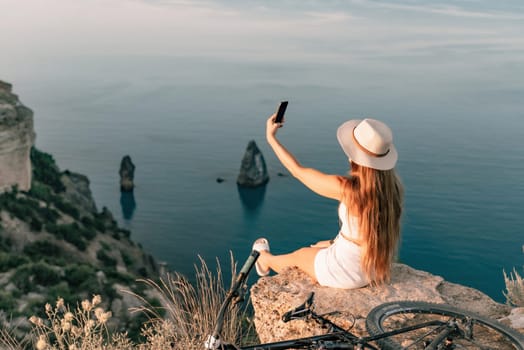 Selfie woman in cap and tank top making selfie shot mobile phone post photo social network outdoors on sea background beach people vacation lifestyle travel concept