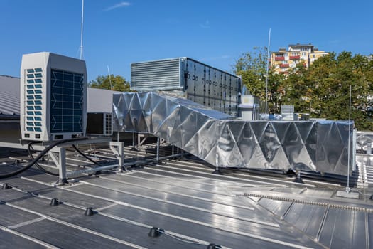 System air conditioning and ventilation solutions for large sports halls. Cooling system components mounted on the roof slope.