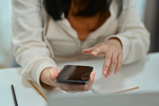 Young woman hand texting text message on mobile phone. Communication, technology and lifestyle concept.