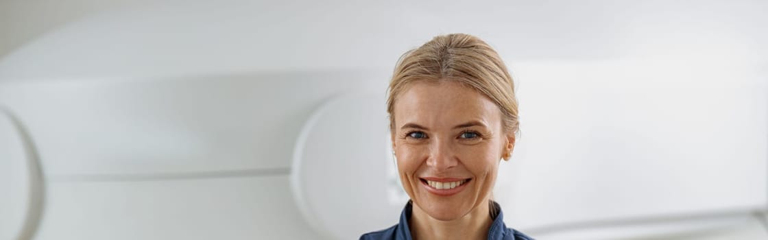 Doctor radiologist on background of MRI or CT Scan with patient. High-Tech medical equipment