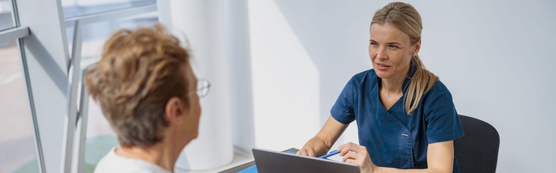 Female doctor fills out the medical report form on medical care of patients during appointment