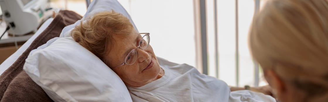 Doctor supporting a sick patient before medical procedures in a hospital room. High quality photo