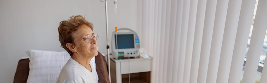 Smiling senior female patient in the ward of modern medical clinic. High quality photo