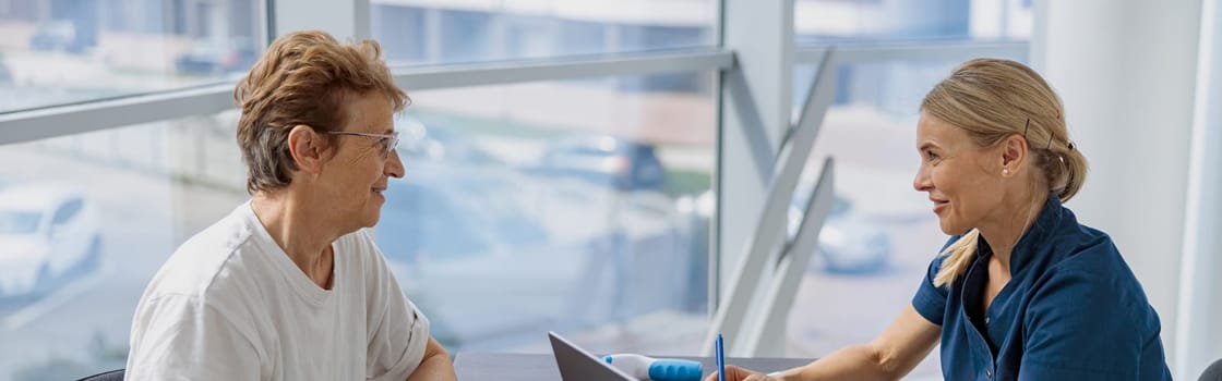 Female doctor fills out the medical report form on medical care of patients during appointment