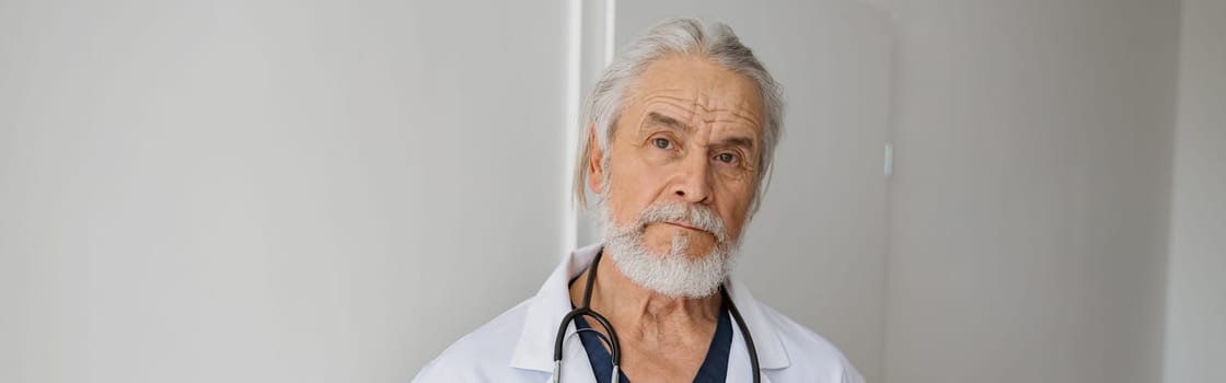 Portrait of doctor standing in medicine clinic hall and looking camera. High quality photo