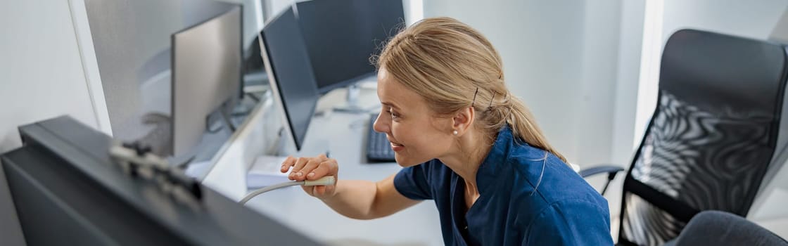 Nurse on Duty makes announcement into microphone at Reception Desk. High quality photo