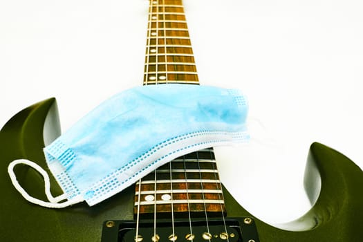 a stringed musical instrument, with a fretted fingerboard,incurved sides, and six or twelve strings, played by plucking or strumming with the fingers or a plectrum. body electric guitar with tremolo