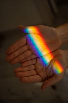 Rainbow ray on a woman's hand