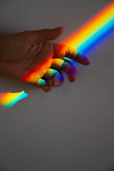 Rainbow ray on a woman's hand