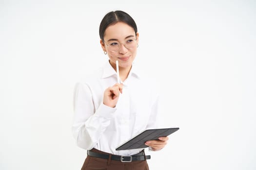 Beautiful asian woman, entrepreneur with digital tablet, working on business project, leading meeting and looking at notes on device, white background.