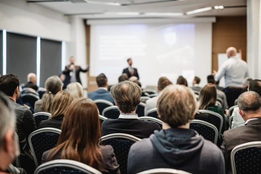 I have a question. Group of business people sitting at the chairs in conference hall. Businessman standing up asking a question. Conference and Presentation. Business and Entrepreneurship.