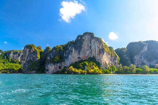 Huge cliff rocks in azure water, Railay beach, Ao Nang, Krabi, Thailand.