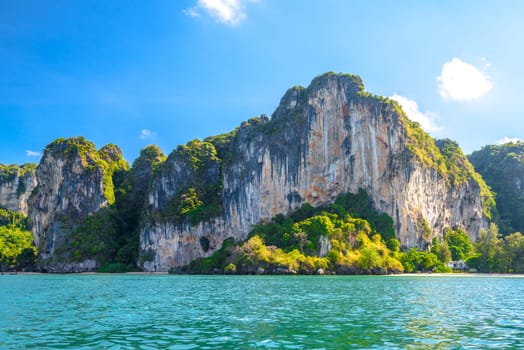 Huge cliff rocks in azure water, Railay beach, Ao Nang, Krabi, Thailand.