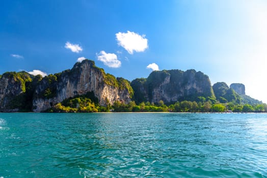 Huge cliff rocks in azure water, Railay beach, Ao Nang, Krabi, Thailand.