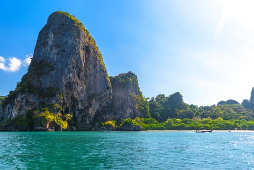 Huge cliff rocks in azure water, Railay beach, Ao Nang, Krabi, Thailand.