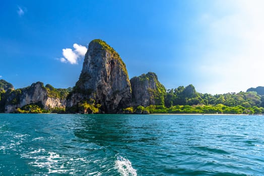 Huge cliff rocks in azure water, Railay beach, Ao Nang, Krabi, Thailand.