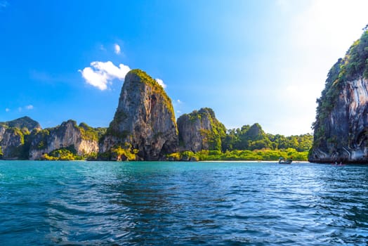 Huge cliff rocks in azure water, Railay beach, Ao Nang, Krabi, Thailand.