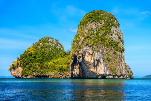 Huge cliff rock in azure water, Ko Rang Nok, Ao Phra Nang Beach, Ao Nang, Krabi, Thailand.