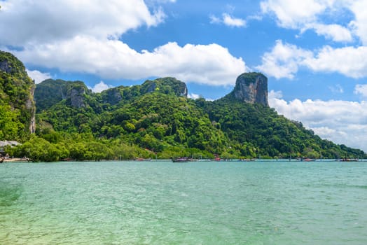 Rocks and cliffs covered with tropical trees, azure water on Ao Phra Nang Beach, Railay east Ao Nang, Krabi, Thailand.