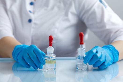 Doctor using pipette for taking samples for test in special chemical laboratory or private clinic