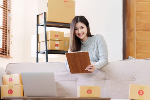 Small businesses SME owners female entrepreneurs check online orders to prepare to pack the boxes, sell to customers, sme business ideas online.