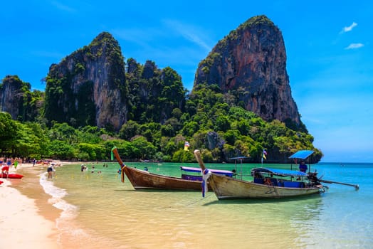 Long tail boats and rocks on Railay beach west, Ao Nang, Krabi, Thailand.