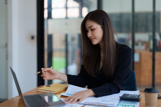 Beautiful young teen asian business woman meeting at on computer laptop with planning working on financial document, tax, exchange, accounting and Financial advisor. High quality photo