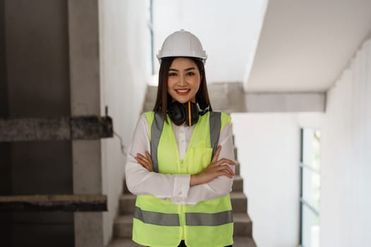 woman smile with multi ethnic engineer brainstorming and measuring for cost estimating on blueprint and floor plan drawings about design architectural and engineering for houses and buildings.