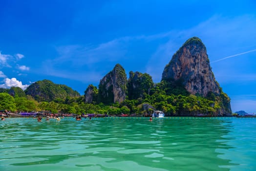 Rocks and cliffs, water and tropical white sand beach, Railay beach west, Ao Nang, Krabi, Thailand.