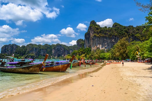 KRABI, THAILAND- MARCH 2018: Long tail boats and rocks on Railay beach west, Ao Nang, Krabi, Thailand.
