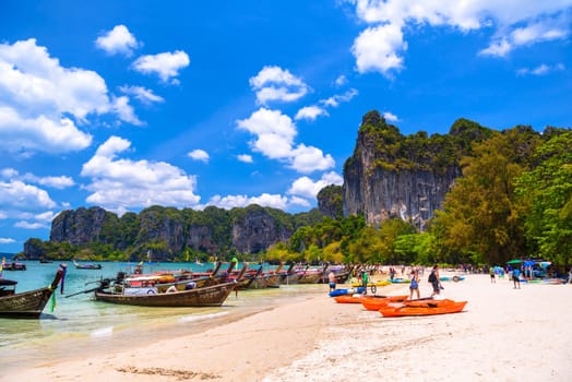 KRABI, THAILAND- MARCH 2018: Long tail boats and rocks on Railay beach west, Ao Nang, Krabi, Thailand.