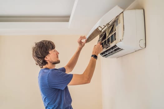 technician service removing air filter of the air conditioner for cleaning.