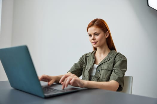 portrait of a cute woman sitting at work at a laptop and thinking things over. High quality photo