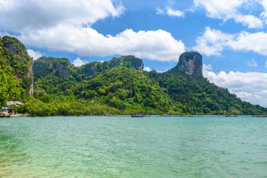 Rocks and cliffs covered with tropical trees, azure water on Ao Phra Nang Beach, Railay east Ao Nang, Krabi, Thailand.