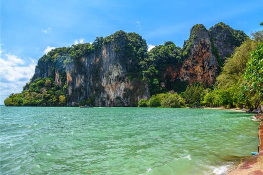 Rocks and cliffs covered with tropical trees, azure water on Ao Phra Nang Beach, Railay east Ao Nang, Krabi, Thailand.