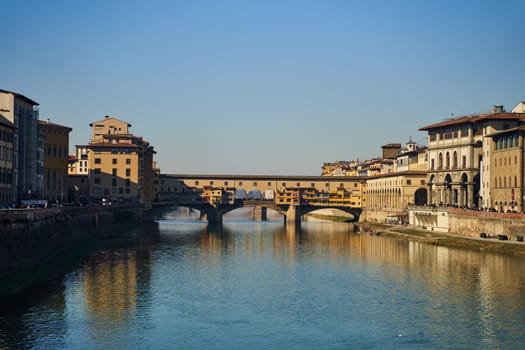 Florence, Italy - 12.02.2023: View of the famous Ponte alle Grazie bridge and the Arno river in Florence. High quality photo