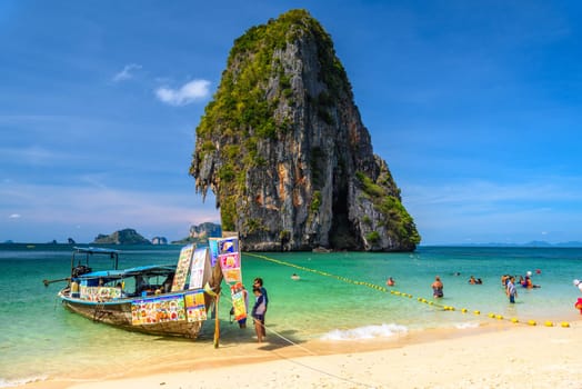 KRABI, THAILAND- MARCH 2018: Long tail boats and cliff rock in azure water, Ko Rang Nok, Ao Phra Nang Beach, Ao Nang, Krabi, Thailand.